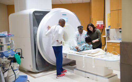 Patient Aaliyah goes through MRI scanner