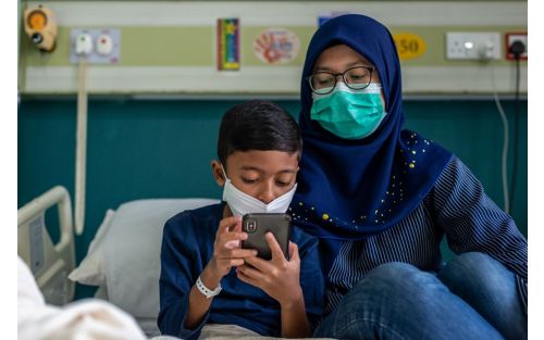 woman and child wearing face masks