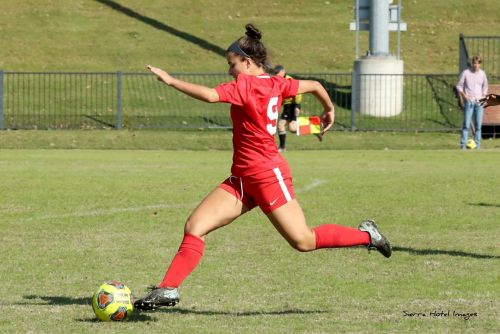 How writing thoughts and feelings can help during cancer treatment. The photo shows a young woman in a soccer uniform kicking a soccer ball..