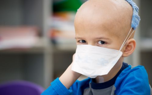 Young cancer patient wearing a mask 