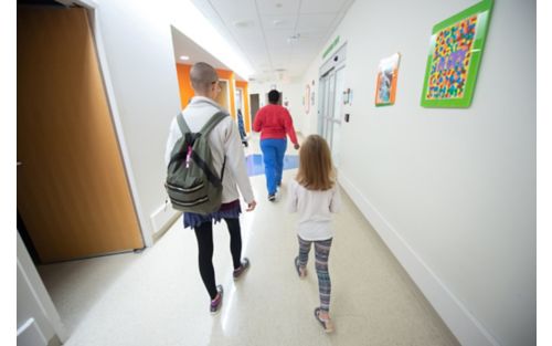 Patient and staff walking down hall