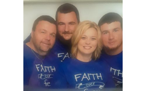 Patient Evan with family in group photo