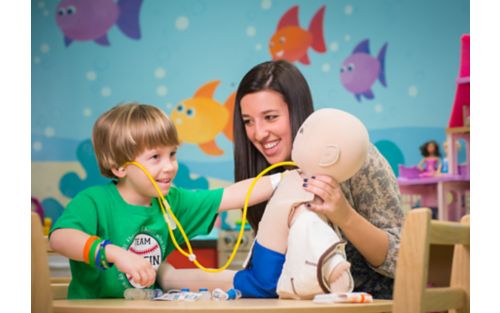 Male patient playing with Child Life Specialist