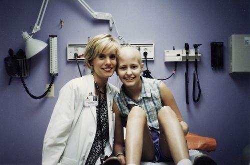 Patient sitting in an examination room with a care team member.