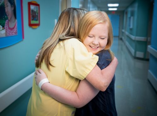 Patients and their families should develop healthy boundaries with their care team members. In this picture, a care team member hugs a patient.