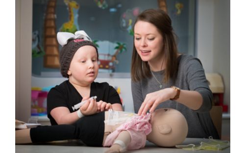 Patient plays with medical doll