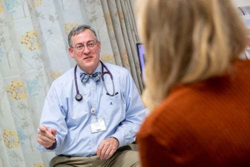 The end of childhood cancer treatment is exciting, but it can create anxiety. In this image, a pediatric cancer survivor talks to her physician in a clinic waiting room.