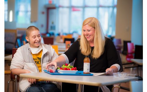 Child with nutritionist at cafeteria