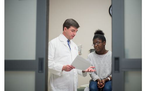 Dr. Greg Armstrong with a patient in hospital room