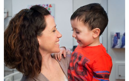 Mother holding young son in arms