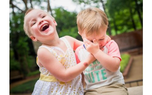 Two small children playing outdoors