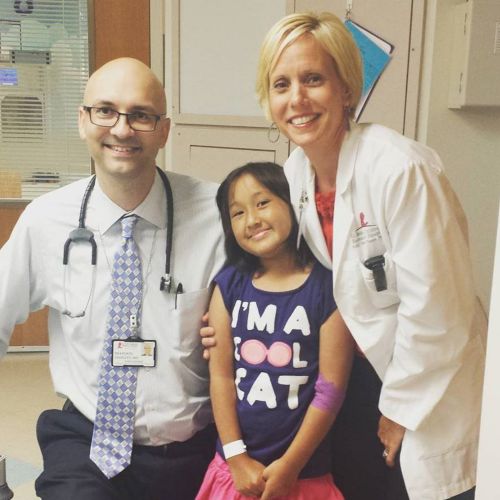 Patient, center, between two care team members