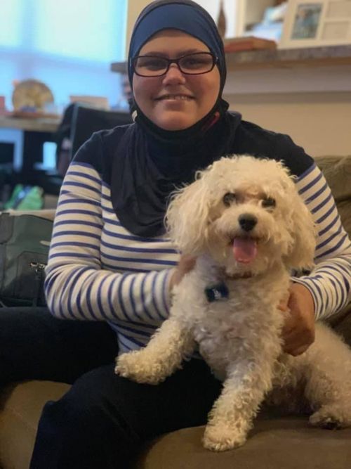 Nora in November 2020 with her sister's dog, Angel. Her sister Deena was inspired to go to medical school because of Nora's experience as a cancer patient.