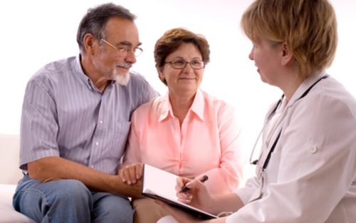 Doctor speaking to older couple
