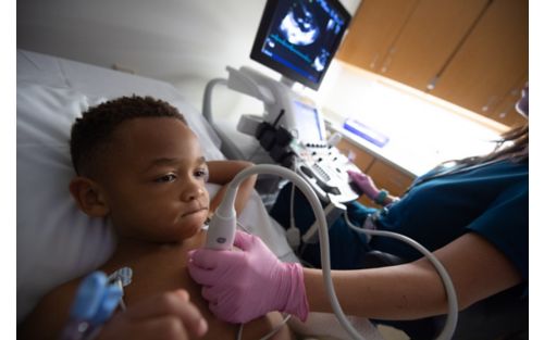 Child getting an ultrasound in chest