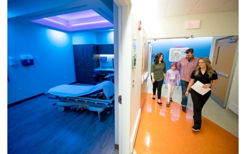 Patient with nurse and family walking to ultrasound 