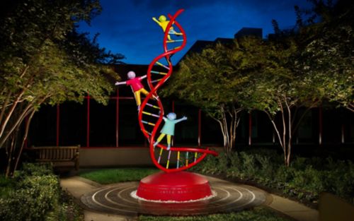 statue of children playing on a dna strand