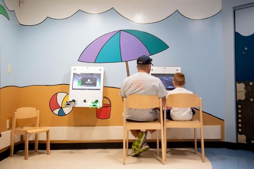 Father and son sitting at computer