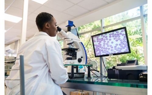 Female pathologist at microscope