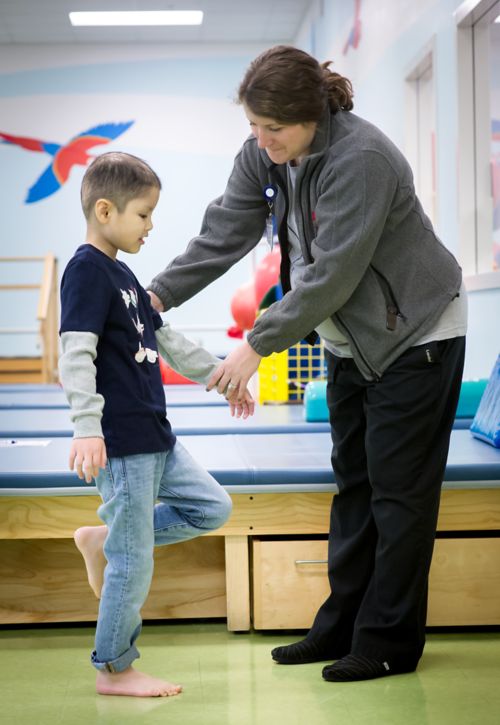 Physical therapist working with pediatric cancer patient