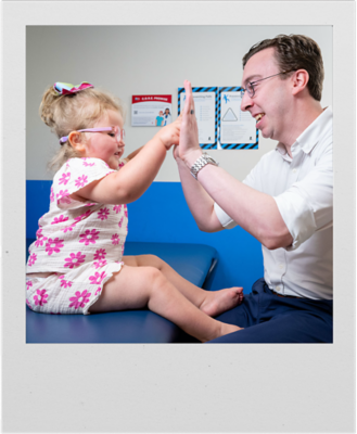 A St. Jude patient plays with Samuel Hughes, Center of Experimental Neurotherapeutics operations manager, during her checkup.