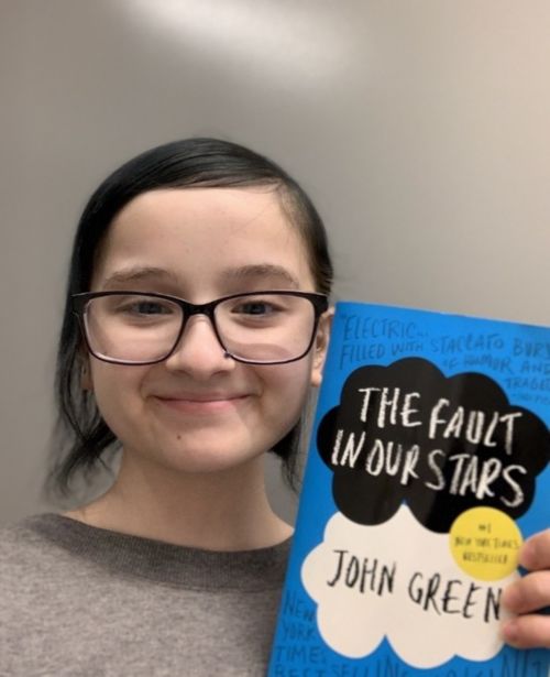 image of girl holding a book