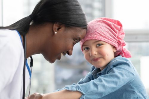 Female doctor with child cancer patient