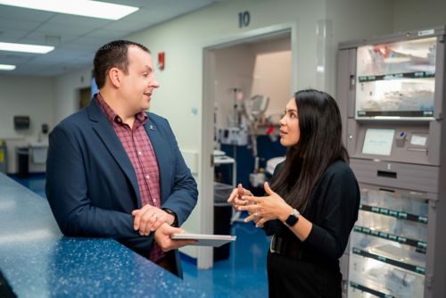Two people talking at a counter
