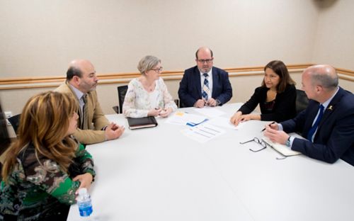 Sima Jeha, MD, and colleagues meet around a table