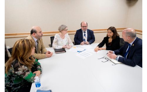 Sima Jeha, MD, and colleagues meet around a table