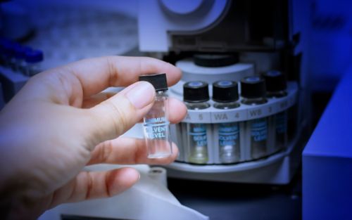 Image of hand holding lab samples