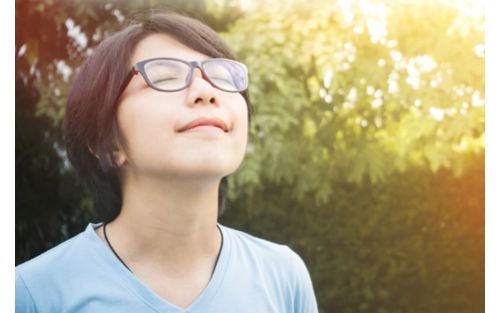 Woman deep breathing outside