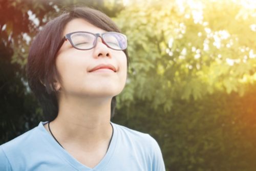 Woman deep breathing outside