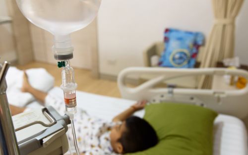 Boy laying on hospital bed in treatment