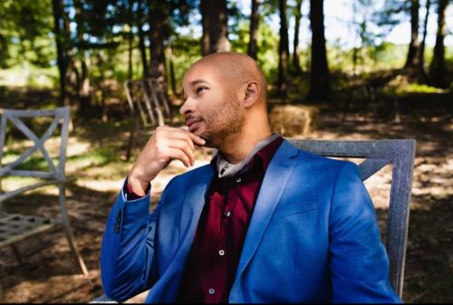 Ricky Terry Jr. sits on chair outdoors