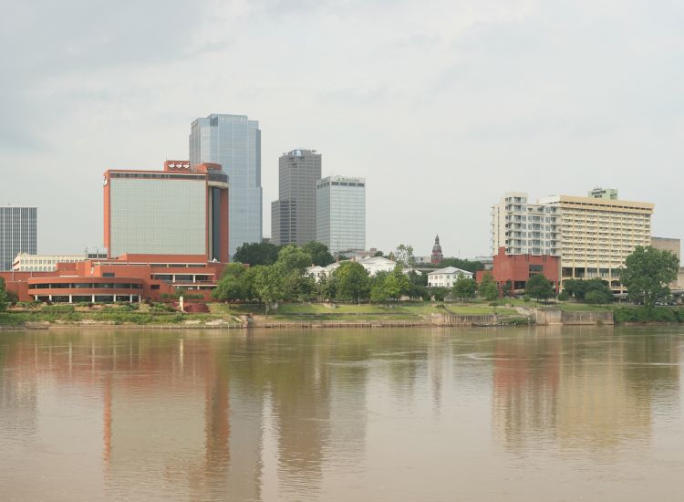View of Riverfront Park from across the Mississippi River with downtown Little Rock in the distance.