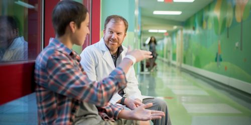 Doctor and patient sitting on bench talking