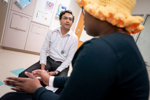 Dr. Akshay Sharma speaking with a patient