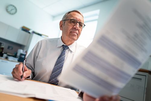 photo of Victor Santana looking at document