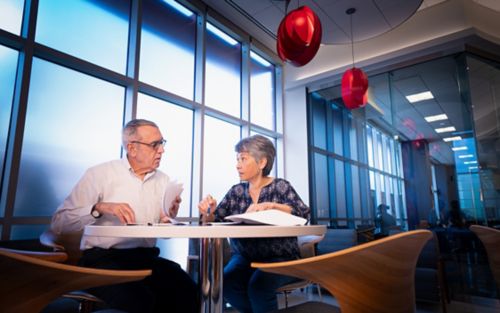 Panel of two faculty members sitting at table 