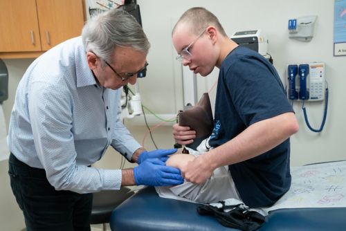 Doctor examining patient's knee