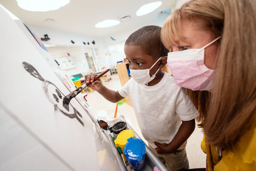 Child painting with child life specialist