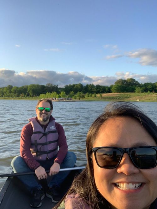 Photo of man and woman in boat on lake