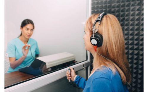 A woman undergoing an audiogram hearing test