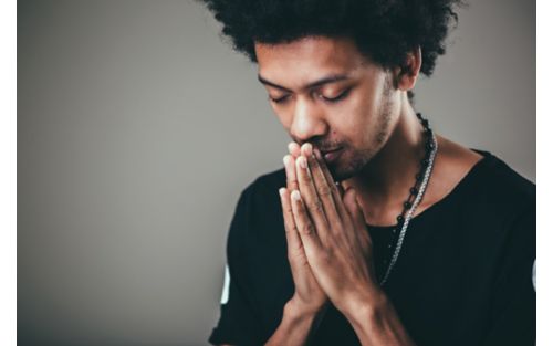Man closes eyes while meditating