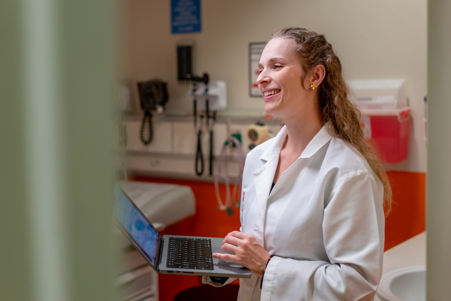 Dr. Brittany Simpson in white coat and clinical setting