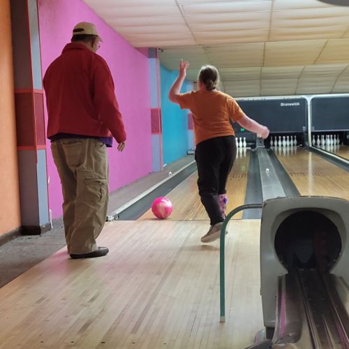 man and girl bowling