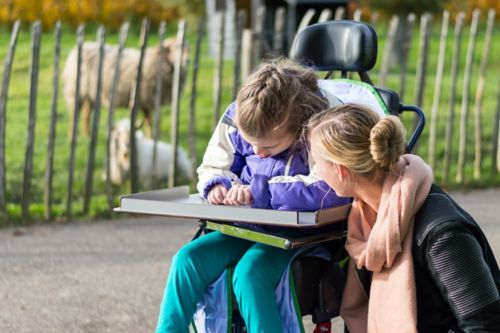 Social worker with patient in a wheelchair