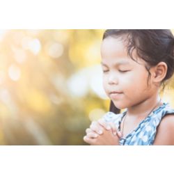 Female child praying with eyes closed