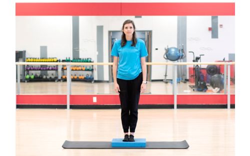 Woman practices standing balance.